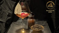 a glass of wine and a bowl of tea