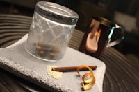 a glass with cinnamon sticks and a cinnamon stick on it