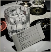 a glass of ice with a note on it