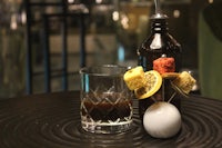 a glass with a drink on it