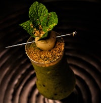 a green drink with a mint leaf on top