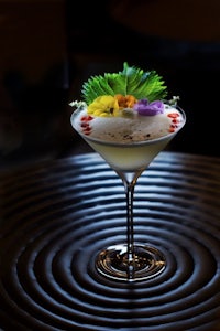 a martini is sitting on top of a black table