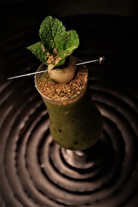 a green drink with a mint leaf on top